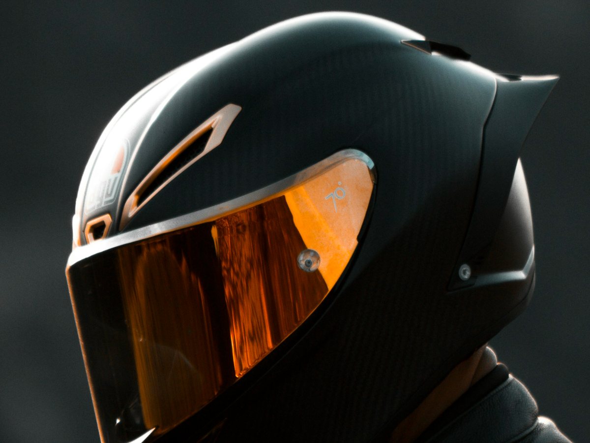 Rider in a black full-face motorcycle helmet with a tinted visor