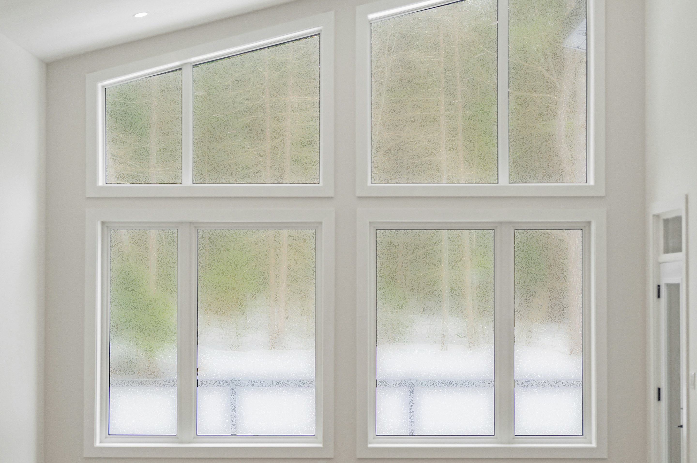 The same windows untreated, fogged over with condensation